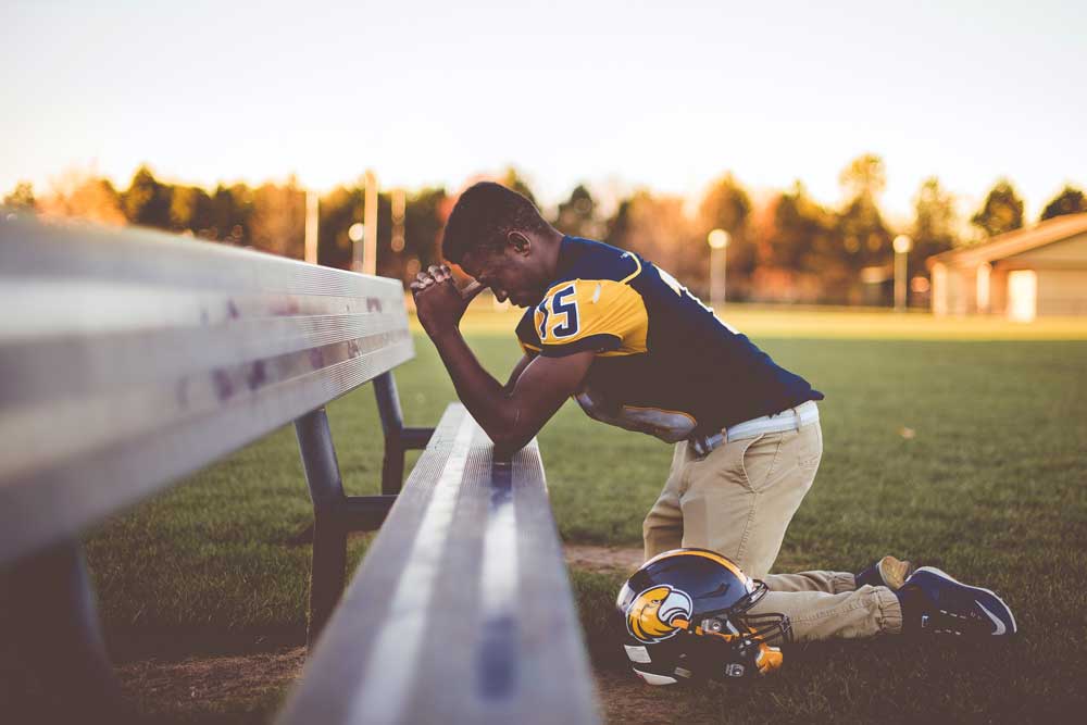 NextGen Sports Surfaces football player praying